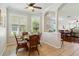 Eat-in kitchen and dining area that features multiple windows, plantation shutters, and ceramic tile flooring at 4567 Whispering Oaks Dr, North Port, FL 34287