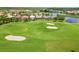 An aerial view of the lush green golf course surrounded by beautiful homes and ponds at 4567 Whispering Oaks Dr, North Port, FL 34287