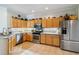 Bright kitchen with stainless steel appliances, light wood cabinets, and mosaic tile backsplash at 4567 Whispering Oaks Dr, North Port, FL 34287