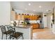 Kitchen boasts stainless steel appliances, light wood cabinets, and a breakfast bar with barstool seating at 4567 Whispering Oaks Dr, North Port, FL 34287