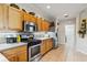 Kitchen offers stainless steel appliances, lots of counter space, and beautiful wooden cabinets at 4567 Whispering Oaks Dr, North Port, FL 34287