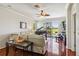 Living room showcases hardwood floors, a ceiling fan, and a grand piano at 4567 Whispering Oaks Dr, North Port, FL 34287