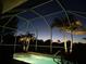 Inviting pool surrounded by lush tropical landscaping with screened-in enclosure, creating a serene outdoor space at 4567 Whispering Oaks Dr, North Port, FL 34287