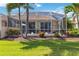 Screened-in lanai, pool and backyard surrounded by palm trees and tropical foliage at 4567 Whispering Oaks Dr, North Port, FL 34287