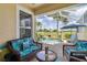 Screened-in patio featuring comfortable seating next to a sparkling in-ground pool at 4567 Whispering Oaks Dr, North Port, FL 34287