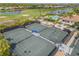 Tennis courts are adjacent to a community pool, golf course, and pond in a private community at 4567 Whispering Oaks Dr, North Port, FL 34287