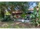 Backyard patio with garden landscaping and red tiled roof at 5052 Kingsley Rd, North Port, FL 34287