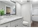 Bathroom with granite countertop, white cabinets, and walk in shower at 5052 Kingsley Rd, North Port, FL 34287