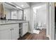 Modern bathroom featuring double sinks, granite counters, and a glass-enclosed shower at 5052 Kingsley Rd, North Port, FL 34287