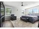 Cozy bedroom with ample natural light, dark hardwood flooring, and comfortable seating for a welcoming retreat at 5052 Kingsley Rd, North Port, FL 34287