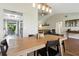 Open concept dining area with wood table and views of the living room at 5052 Kingsley Rd, North Port, FL 34287