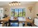 Well-lit dining room with wood table and outside views at 5052 Kingsley Rd, North Port, FL 34287