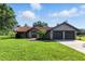 Charming single-story home featuring a well-manicured lawn and a two-car garage at 5052 Kingsley Rd, North Port, FL 34287