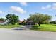 Charming single-story home with a well-maintained lawn, mature trees, and a spacious driveway at 5052 Kingsley Rd, North Port, FL 34287