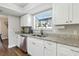 Bright kitchen featuring white cabinets, stainless steel appliances, and granite countertops at 5052 Kingsley Rd, North Port, FL 34287