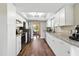 Modern kitchen with white cabinets, stainless steel appliances, and granite countertops at 5052 Kingsley Rd, North Port, FL 34287