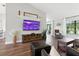 Bright living room with hardwood floors, a mounted TV, and comfortable seating at 5052 Kingsley Rd, North Port, FL 34287