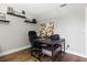 Office area with dark desk, rolling chair, and decorative shelving at 5052 Kingsley Rd, North Port, FL 34287