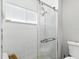 Modern tiled shower with glass door and dual shower heads at 5052 Kingsley Rd, North Port, FL 34287