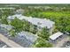 Aerial view of condominium showing garages, landscaping and parking at 5146 Northridge Rd # 305, Sarasota, FL 34238