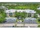 An aerial view of a condo building with lush trees and well-maintained parking at 5146 Northridge Rd # 305, Sarasota, FL 34238