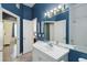 Well-lit bathroom features a vanity with mirror, adjacent rooms, and neutral color palette at 5146 Northridge Rd # 305, Sarasota, FL 34238