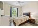 Bright bedroom with a large window, comfortable bed, and a dresser providing ample storage at 5146 Northridge Rd # 305, Sarasota, FL 34238