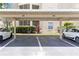 Assigned carport parking featuring reserved parking spaces and landscaping at 5146 Northridge Rd # 305, Sarasota, FL 34238