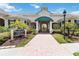 Charming clubhouse entrance with well-maintained landscaping, elegant signage, and a welcoming brick pathway at 5146 Northridge Rd # 305, Sarasota, FL 34238