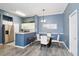 Cozy dining area features modern lighting, sleek table set, and seamless transition to a charming kitchen at 5146 Northridge Rd # 305, Sarasota, FL 34238