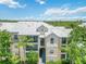 Exterior of condo building with palm trees, landscaping, and stairway at 5146 Northridge Rd # 305, Sarasota, FL 34238