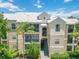 Exterior of condo building with palm trees, landscaping, and stairway at 5146 Northridge Rd # 305, Sarasota, FL 34238