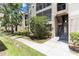 Tan condo building featuring outdoor stairwell, landscaped grounds, and sidewalks at 5146 Northridge Rd # 305, Sarasota, FL 34238