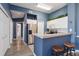 Bright kitchen showcases stainless steel fridge, white cabinetry, and breakfast bar with stool seating at 5146 Northridge Rd # 305, Sarasota, FL 34238