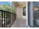Screened lanai with metal railings and view of the green landscaping and a residential building at 5146 Northridge Rd # 305, Sarasota, FL 34238