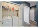 Functional laundry room featuring washer, dryer, and organized shelving for supplies at 5146 Northridge Rd # 305, Sarasota, FL 34238