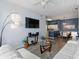 Comfortable living room featuring a white sofa, modern lighting, a tv, and an open floorplan at 5146 Northridge Rd # 305, Sarasota, FL 34238