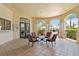 Inviting patio area with comfortable seating, an arched entrance, and views of lush landscaping and a pool at 5146 Northridge Rd # 305, Sarasota, FL 34238