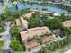 Aerial view of a complex near a body of water with mature trees and designated parking at 5230 Lake Arrowhead Trl # 29, Sarasota, FL 34231