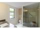 Bathroom with tiled shower and glass door, granite counters and tiled floor at 5230 Lake Arrowhead Trl # 29, Sarasota, FL 34231