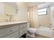 Well-lit bathroom featuring a tub with shower and an updated vanity with a round mirror at 5230 Lake Arrowhead Trl # 29, Sarasota, FL 34231