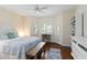 Bright bedroom with hardwood floors, plantation shutters, ceiling fan, desk and bench at 5230 Lake Arrowhead Trl # 29, Sarasota, FL 34231