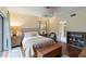 Bedroom with wood floors, neutral walls, ensuite bathroom and door to hall at 5230 Lake Arrowhead Trl # 29, Sarasota, FL 34231