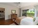 Bedroom boasts deck access, natural light, and rich hardwood flooring at 5230 Lake Arrowhead Trl # 29, Sarasota, FL 34231