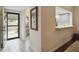 Bright entryway features tile flooring, a decorative mirror, and a pass-through to the kitchen at 5230 Lake Arrowhead Trl # 29, Sarasota, FL 34231