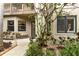 Inviting home entrance with well-maintained landscaping and a cozy bench near the front door at 5230 Lake Arrowhead Trl # 29, Sarasota, FL 34231