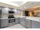 Modern kitchen featuring stainless steel appliances, light countertops, and updated cabinets at 5230 Lake Arrowhead Trl # 29, Sarasota, FL 34231
