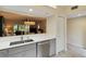 Updated kitchen overlooking the living area, complete with stainless steel appliances and white countertops at 5230 Lake Arrowhead Trl # 29, Sarasota, FL 34231