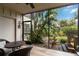 Screened lanai featuring a ceiling fan and a peaceful view of the landscaped backyard at 5230 Lake Arrowhead Trl # 29, Sarasota, FL 34231