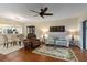 Bright living room featuring hardwood floors, a ceiling fan, and a view of the dining area and kitchen at 5230 Lake Arrowhead Trl # 29, Sarasota, FL 34231